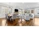 Open-concept living and dining area featuring hardwood floors and abundant natural light with white trim at 2362 Saint Davids Nw Sq, Kennesaw, GA 30152