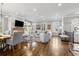 Open-concept living space featuring hardwood floors, dining area, and natural light at 2362 Saint Davids Nw Sq, Kennesaw, GA 30152
