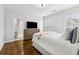 Bright main bedroom with hardwood floors, many windows, and a large ensuite bathroom at 2362 Saint Davids Nw Sq, Kennesaw, GA 30152