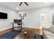 Well-lit office space featuring a desk with dual monitors, hardwood floors, and neutral decor at 2362 Saint Davids Nw Sq, Kennesaw, GA 30152