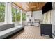 Covered patio features stainless steel grill, beverage center, with wood paneled ceiling and gray sectional sofa at 2362 Saint Davids Nw Sq, Kennesaw, GA 30152