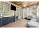Covered porch with ceiling fan, TV, cabinets with beverage center, and gray sectional sofa at 2362 Saint Davids Nw Sq, Kennesaw, GA 30152