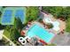 Aerial view of community pool and tennis courts surrounded by lush landscaping at 2362 Saint Davids Nw Sq, Kennesaw, GA 30152