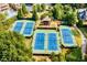 Aerial view of community tennis courts surrounded by lush, mature trees and foliage at 2362 Saint Davids Nw Sq, Kennesaw, GA 30152