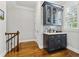 Charming wet bar with dark blue cabinetry, white countertop, tile backsplash, and hardwood flooring at 2362 Saint Davids Nw Sq, Kennesaw, GA 30152