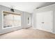 Bedroom with neutral walls and carpet, windows, ceiling fan and large closet doors at 2372 Johnson Rd, Atlanta, GA 30345