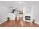 Cozy living room with hardwood floors, fireplace, and open layout to kitchen at 2372 Johnson Rd, Atlanta, GA 30345