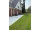 A grass backyard with a concrete patio on a brick house at 2474 Starfire Ln, Loganville, GA 30052