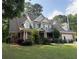 Charming two-story home with brick accents, manicured lawn, and attached garage at 2474 Starfire Ln, Loganville, GA 30052