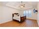 Serene main bedroom with tray ceiling, hardwood floors, and a large window for natural light at 2474 Starfire Ln, Loganville, GA 30052