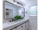 Bathroom vanity with dual sinks, modern lighting, and large mirror at 2736 Joyce Ave, Decatur, GA 30032