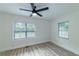 Bedroom with luxury vinyl plank flooring, modern ceiling fan, two windows, and fresh paint at 2736 Joyce Ave, Decatur, GA 30032