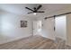Bright bedroom featuring modern ceiling fan, wood-look floors, barn door, and fresh paint at 2736 Joyce Ave, Decatur, GA 30032