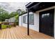 Relaxing front porch with a view, features a black front door and a freshly painted white exterior at 2736 Joyce Ave, Decatur, GA 30032