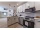 Modern kitchen with stainless steel appliances, sleek cabinets, and stylish pendant lighting at 2736 Joyce Ave, Decatur, GA 30032