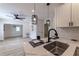 Modern kitchen with stainless steel sink, white cabinets, and open view to living area at 2736 Joyce Ave, Decatur, GA 30032