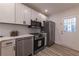 Modern kitchen featuring stainless steel appliances, including range, dishwasher, and refrigerator at 2736 Joyce Ave, Decatur, GA 30032