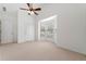 Bright bedroom with neutral carpet, a bay window, ceiling fan, and two doors at 607 Little Shoals Ct, Canton, GA 30115