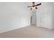 Bright bedroom featuring neutral carpet, ceiling fan and white door to closet at 607 Little Shoals Ct, Canton, GA 30115