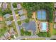 Overhead view of community amenities with tennis courts, swimming pool, and ample parking, all within a beautifully landscaped area at 607 Little Shoals Ct, Canton, GA 30115