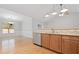 Bright kitchen area with modern lighting, stainless steel dishwasher, and dining area with large windows at 607 Little Shoals Ct, Canton, GA 30115
