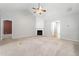 Open living room with a fireplace and neutral carpet at 607 Little Shoals Ct, Canton, GA 30115