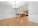 Spacious, open-concept living area with hardwood floors flowing into the kitchen and fireplace area at 607 Little Shoals Ct, Canton, GA 30115
