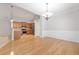 Open-concept living space with hardwood floors connecting kitchen, dining, and living areas at 607 Little Shoals Ct, Canton, GA 30115