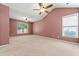 Spacious main bedroom featuring plush carpet, ceiling fans, and bright windows at 607 Little Shoals Ct, Canton, GA 30115