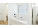 White bathtub and tile detail window in a bathroom with shower stall at , Dallas, GA 30157