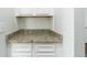 Close-up of a white cabinet with a speckled countertop and a white subway tile backsplash at , Dallas, GA 30157