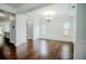 Sunlit dining room featuring hardwood floors, crown molding, and stylish light fixture at , Dallas, GA 30157