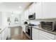 Modern kitchen featuring stainless steel appliances, granite countertops, and white cabinets at , Dallas, GA 30157