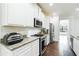 Kitchen featuring stainless steel appliances, granite countertops, white cabinetry, and wood floors at , Dallas, GA 30157