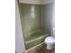 Bathroom features a bathtub, toilet, and modern wood-look flooring at 204 Melanie Ln, Woodstock, GA 30188