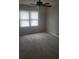 Cozy bedroom featuring soft carpeting, a ceiling fan, and ample natural light through the windows at 204 Melanie Ln, Woodstock, GA 30188