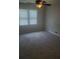 Bright bedroom features neutral carpet, ceiling fan, and natural light at 204 Melanie Ln, Woodstock, GA 30188