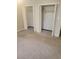 Bedroom featuring neutral carpet and two closets with open doors at 204 Melanie Ln, Woodstock, GA 30188