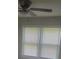Bedroom with two windows featuring blinds and a ceiling fan at 204 Melanie Ln, Woodstock, GA 30188