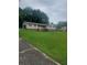 Charming ranch-style home with a spacious lawn, attached garage, and inviting front entrance with stairs at 204 Melanie Ln, Woodstock, GA 30188