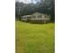 An eye-level exterior view of a two-story home with a large front lawn and traditional curb appeal at 204 Melanie Ln, Woodstock, GA 30188
