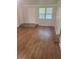Living room featuring beautiful wood floors, neutral wall color, and natural lighting at 204 Melanie Ln, Woodstock, GA 30188