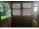 Enclosed porch with wood panels and window views to the outdoors at 204 Melanie Ln, Woodstock, GA 30188
