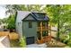 Modern two-story home with a stylish green facade, a private garage, and dual front porches at 224 Cambridge Ave, Decatur, GA 30030