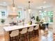 Well-lit kitchen with a central island, pendant lighting, and an adjacent dining area at 224 Cambridge Ave, Decatur, GA 30030
