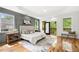 Spacious main bedroom with hardwood floors, tray ceiling, and access to a private balcony at 224 Cambridge Ave, Decatur, GA 30030