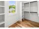 This walk-in closet offers custom shelving and lots of storage, with light pouring in from the window at 224 Cambridge Ave, Decatur, GA 30030