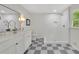 This bathroom offers double sinks, black accents, checkerboard flooring and shower with an orchid at 3512 Hidden Acres Dr, Atlanta, GA 30340