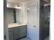 Double vanity sink and enclosed shower stall add appeal to this all-white bathroom at 7695 Baron Rd, Fairburn, GA 30213