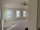 Bright bedroom with a ceiling fan, lots of natural light, and neutral carpeting at 7695 Baron Rd, Fairburn, GA 30213